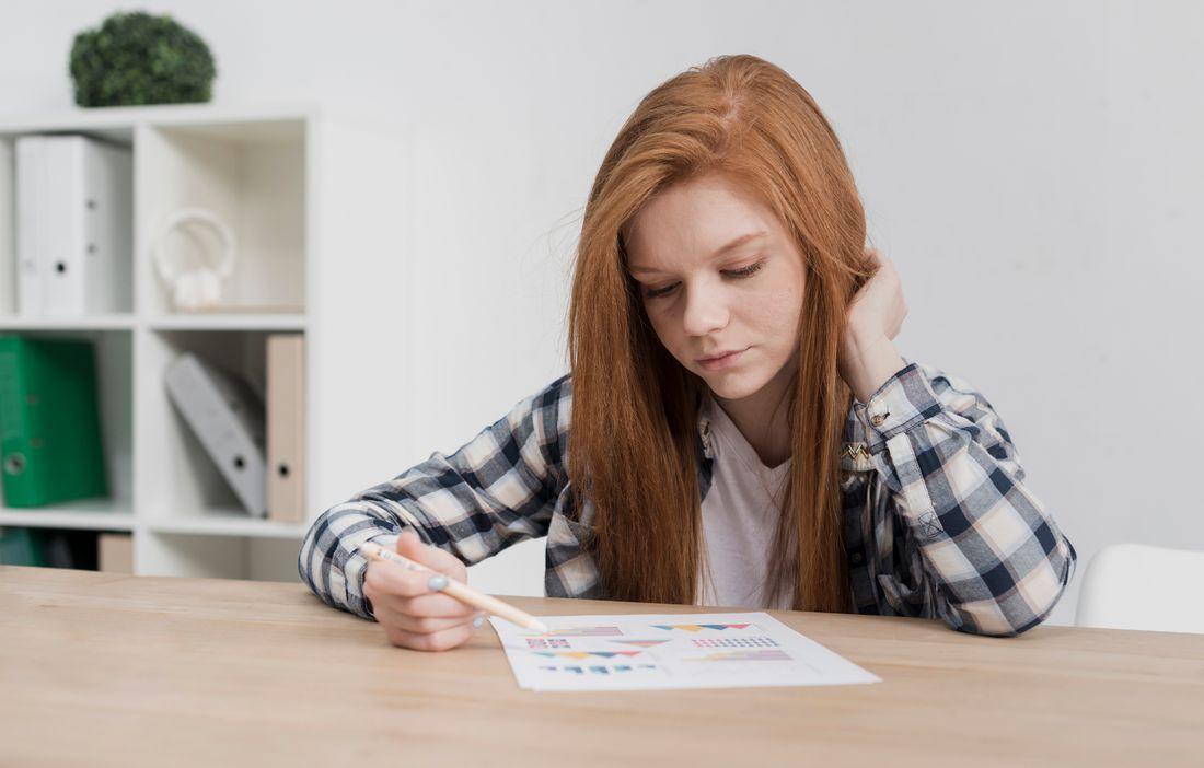 close-up-cute-young-woman-reading-paper.jpg