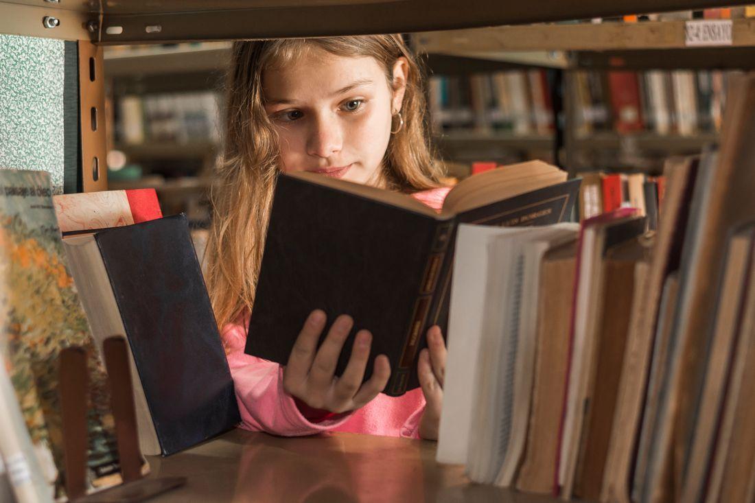 girl-reading-book-bookshelf.jpg