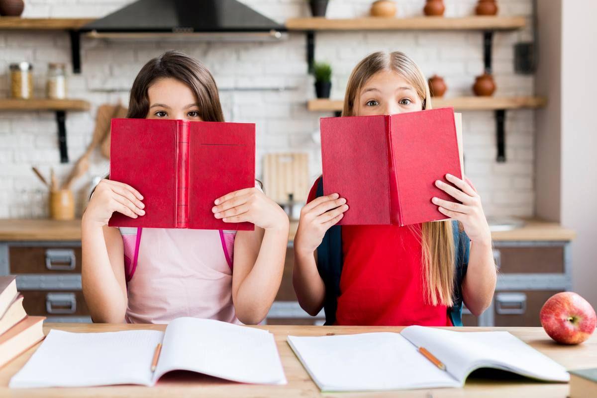 girls-covering-faces-with-books.jpg