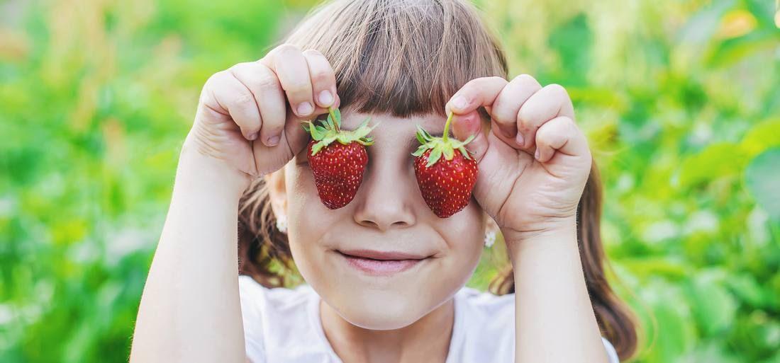 midsection-woman-holding-strawberry.jpg