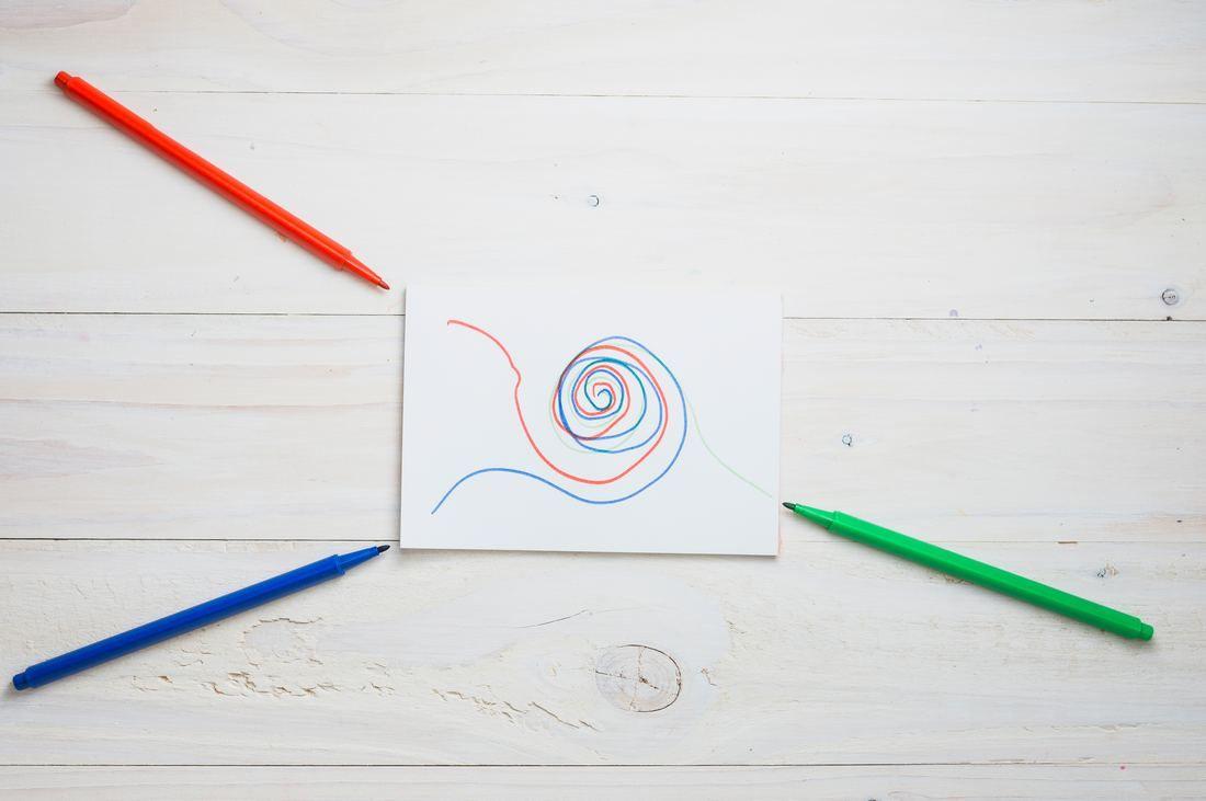 abstract-drawing-white-paper-with-red-green-blue-felt-tip-pen-wooden-desk.jpg
