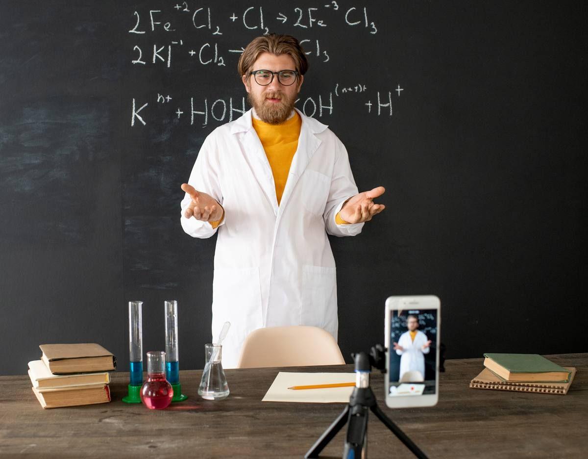 chemistry-teacher-whitecoat-standing-by-blackboard-front-smartphone-while-shooting-himself-online-lesson_m.jpg