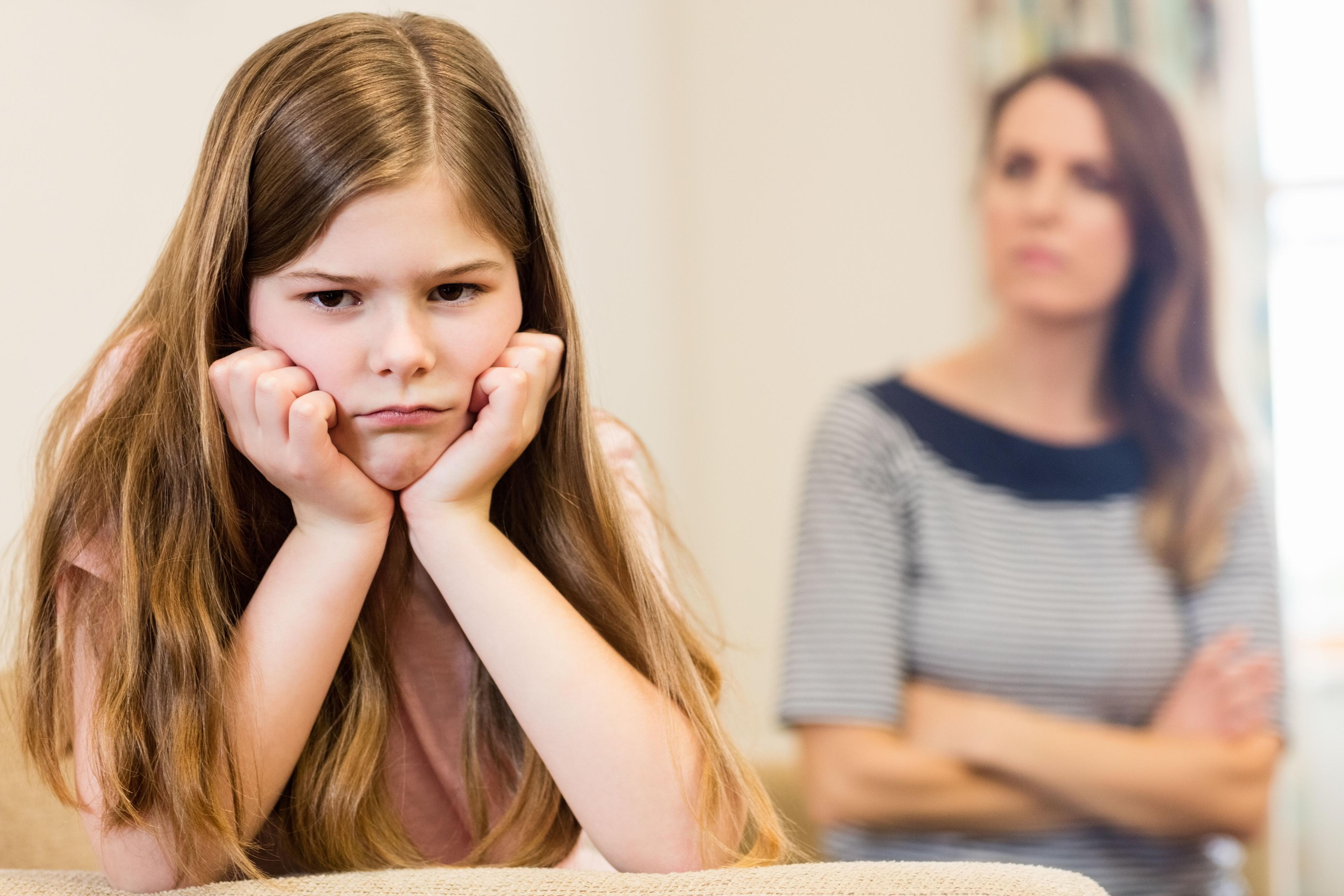 daughter-sitting-upset-with-her-mother-living-room.jpg