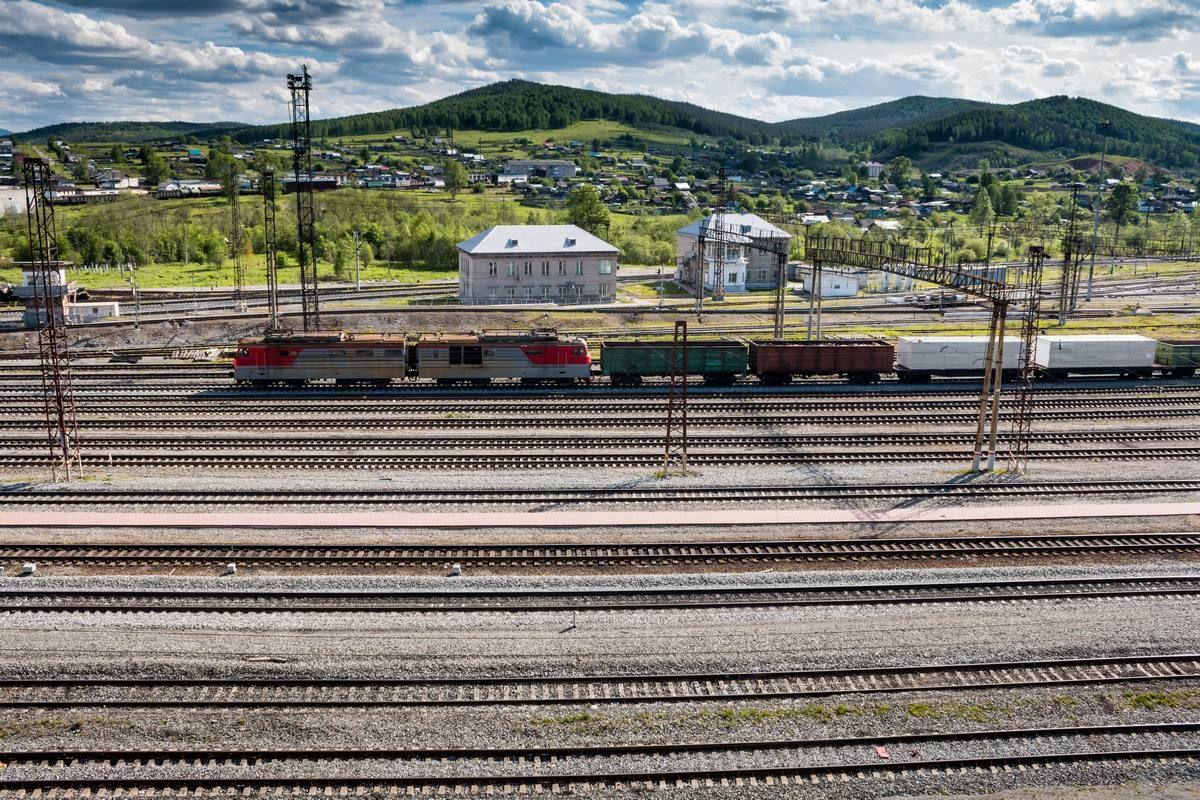 freight-train-passes-through-railway-station-village.jpg