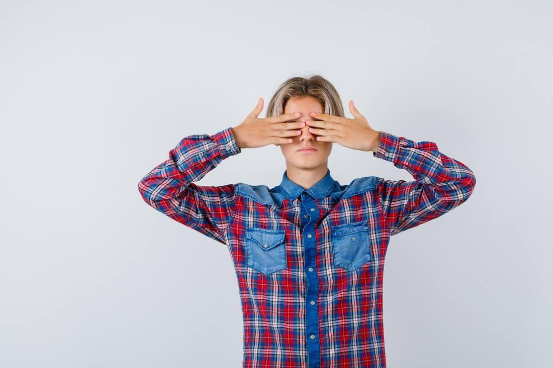 portrait-young-teen-boy-covering-eyes-with-hands-checked-shirt-looking-scared-front-view.jpg