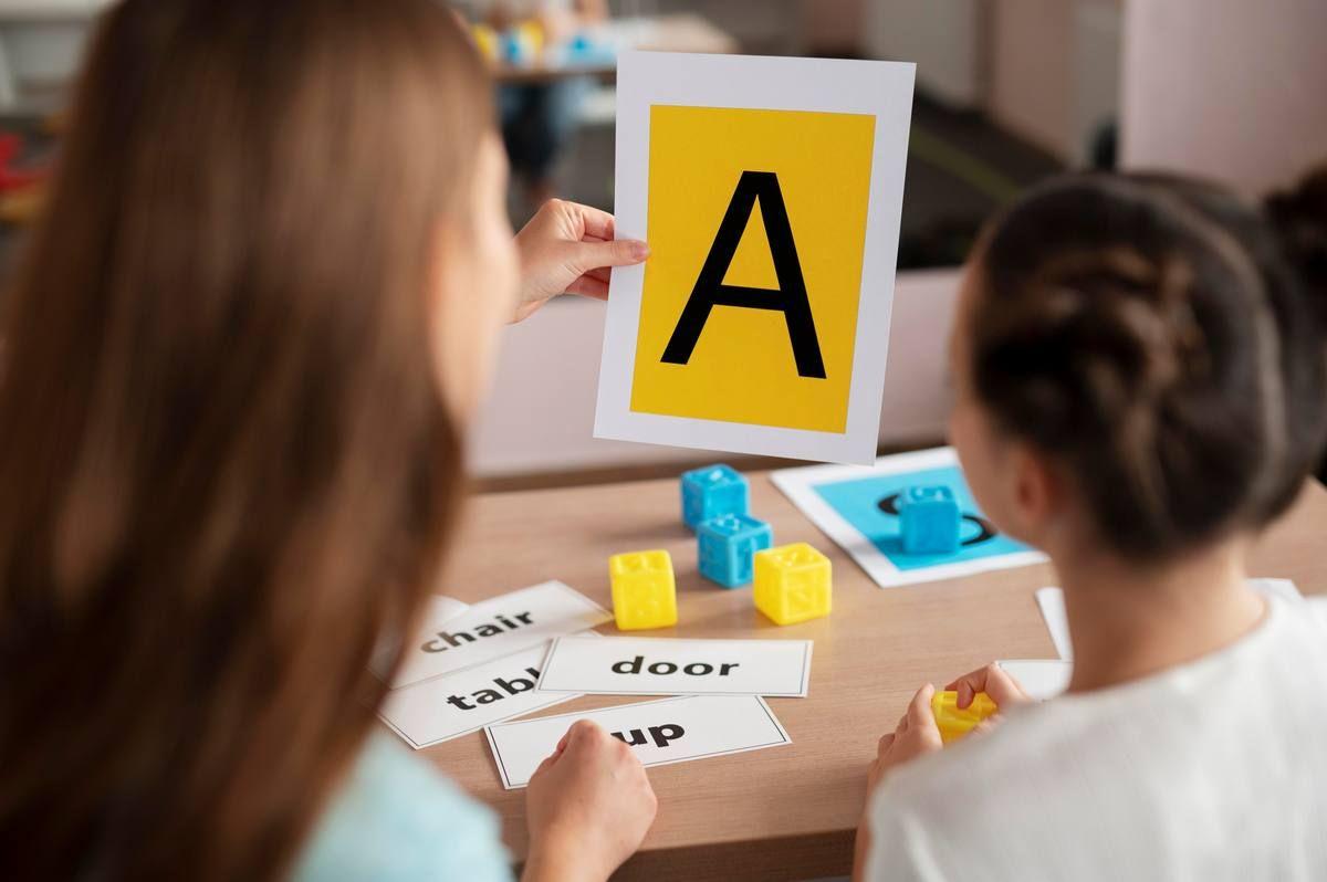 psychologist-helping-little-girl-speech-therapy-indoors.jpg
