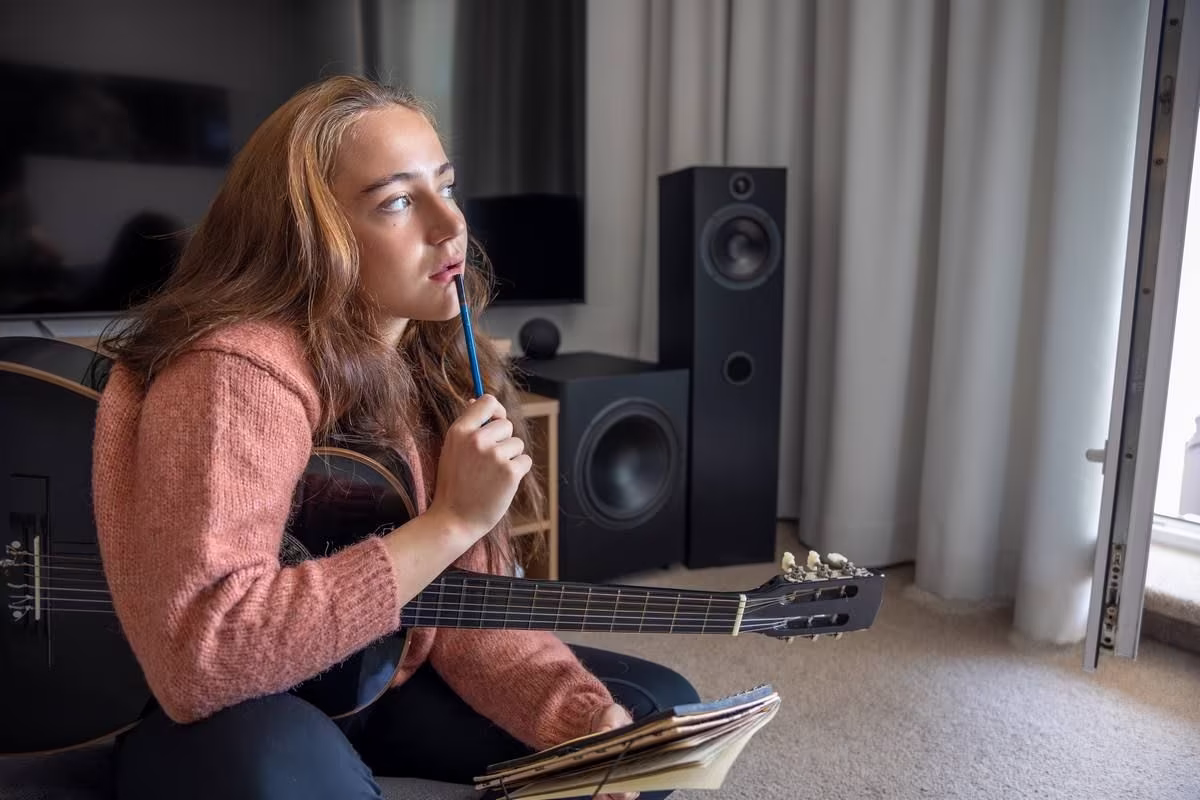 teenage-girl-learning-play-guitar-home-girl-composing-music-guitar.jpg