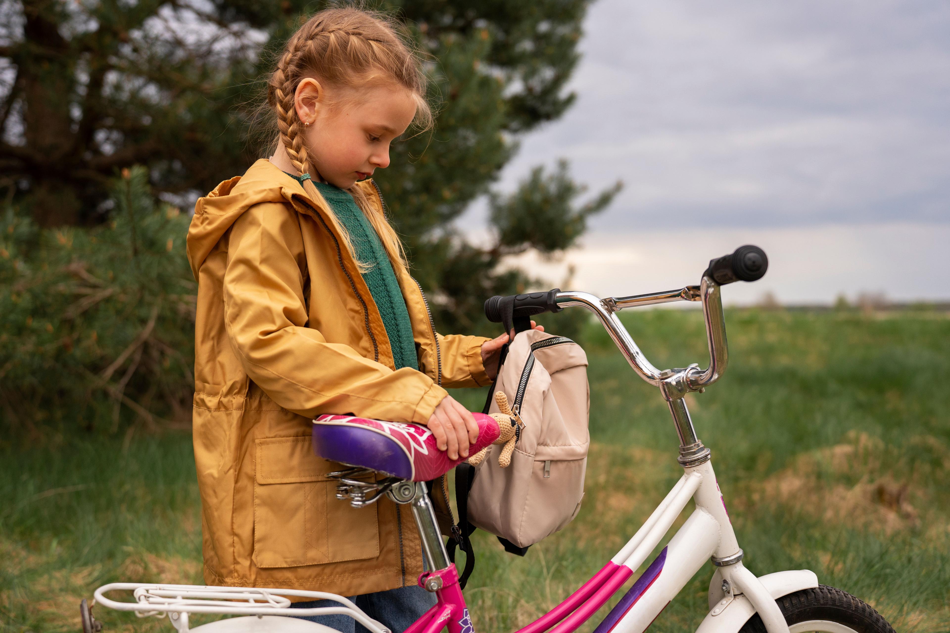 view-little-girl-with-backpack-bike-adventuring-nature.jpg