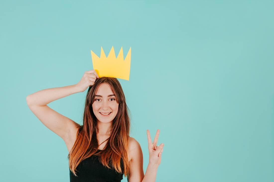 woman-with-paper-crown-gesturing-peace_tn.jpg